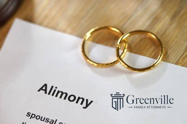 wedding rings on an alimony document